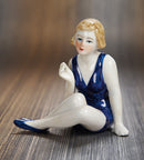 Seated Sunbather in Blue Swim Suit